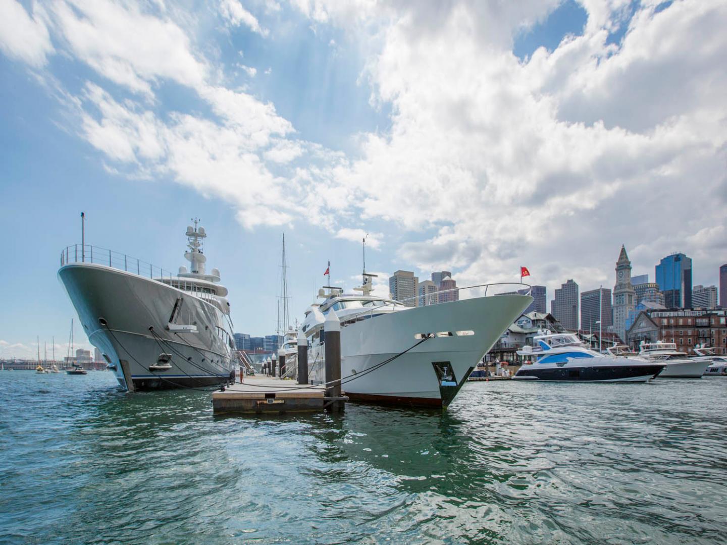 Large yachts on either side of a dock