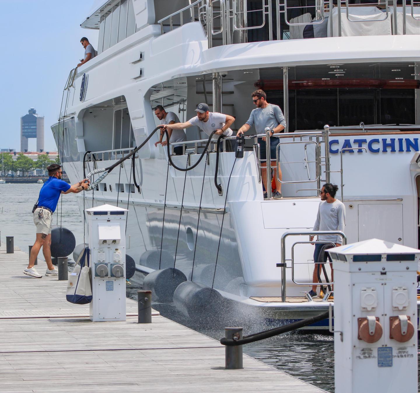 Marina staff assisting yacht crew